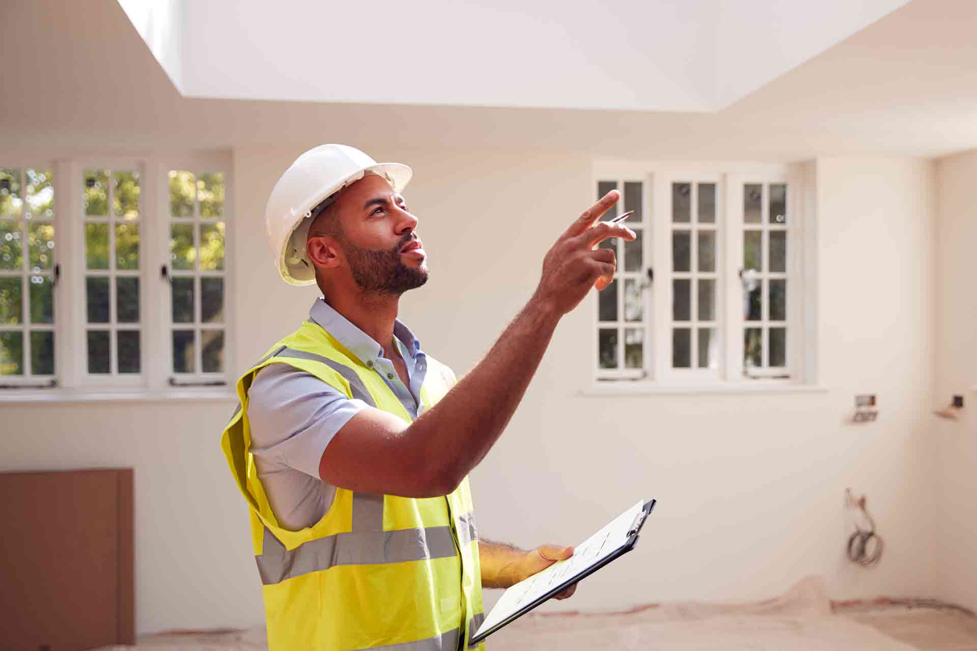 Third Party Wall Surveyors Islington reviewing plans between two parties during a dispute